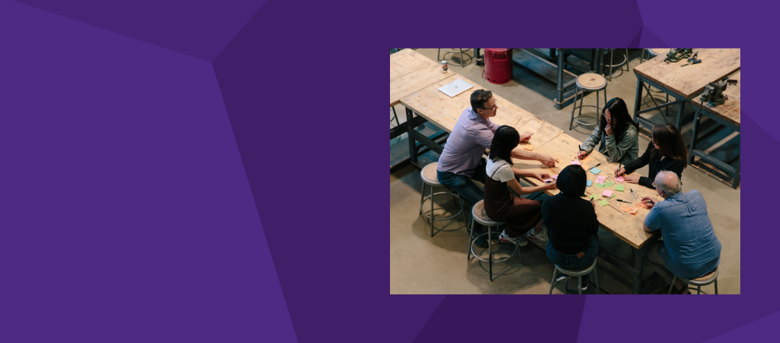 banner with photograph of indiviudals sitting around a table 